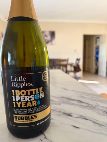 Customer's bottle of Little Ripples Sparkling wine resting on a kitchen counter, showing the label.