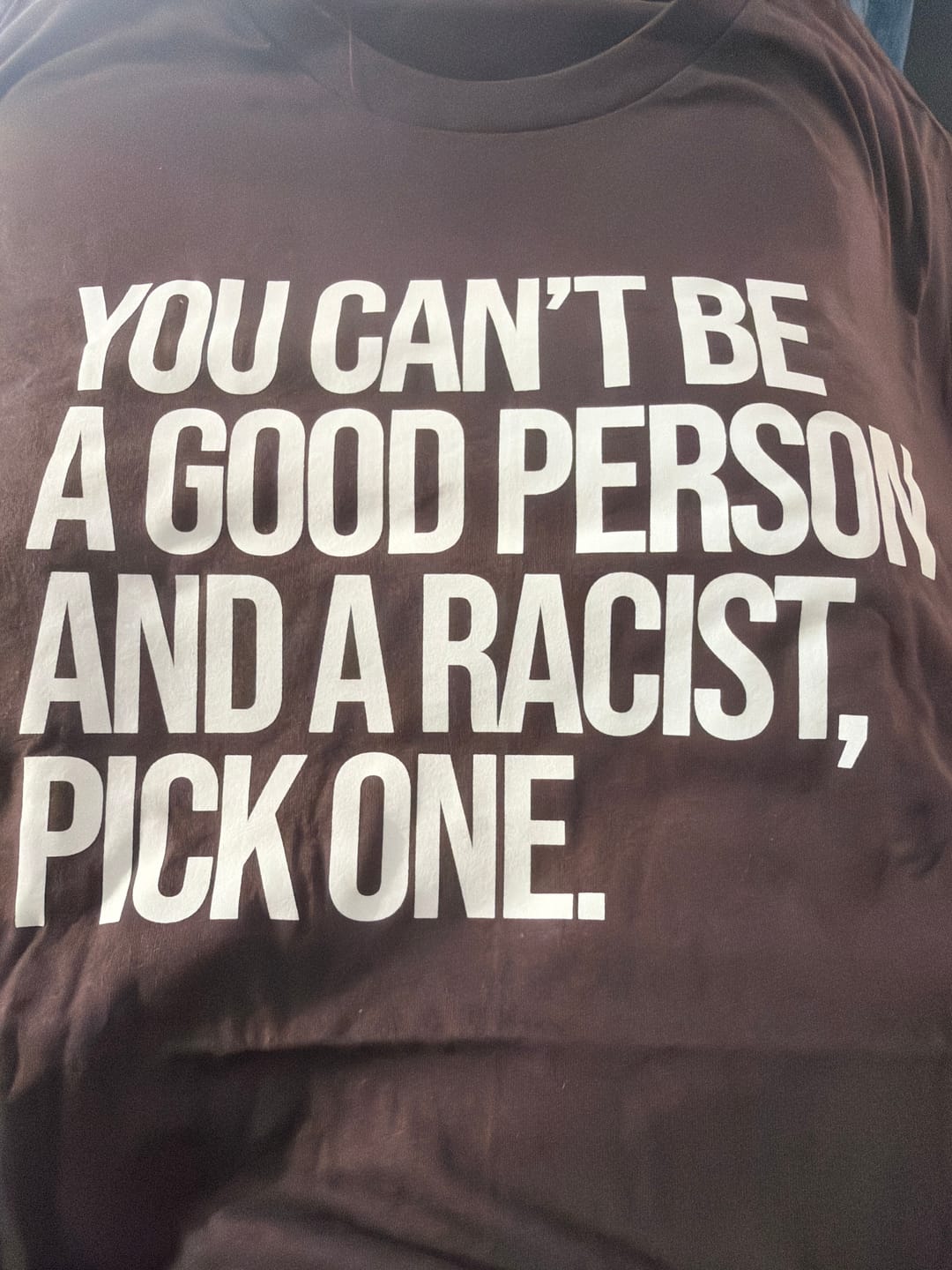 Customer photo review of You Can't Be a Good Person and a Racist Pick One Unisex Tee