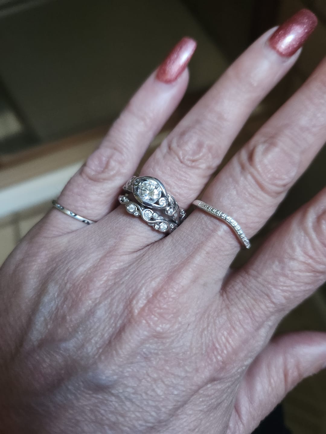 Customer photo review of Bezel Set Round Moissanite Scroll Accents Engagement Ring