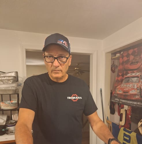 Customer wearing the Snapback Hat from the Freedom Merch Bundle and a black TBM Brakes t-shirt.