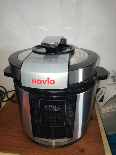 Customer's stainless steel Novio SteelCook multicooker sitting on a wooden surface.