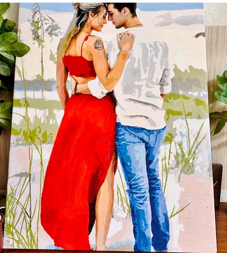 Customer's completed Custom Paint By Numbers portrait showing a couple embracing in a beach setting.