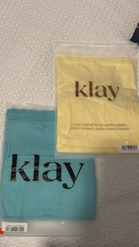 Customer's teal and butter yellow hijabs laid out in their original packaging.