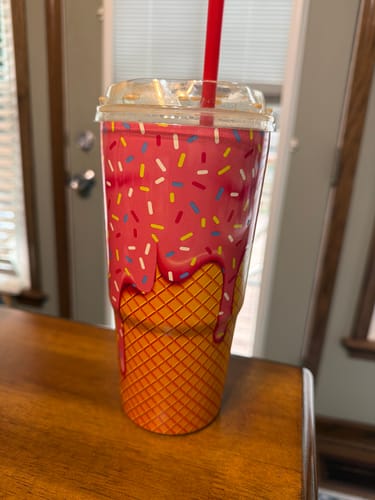 Reviewer's Mystery To-Go Buddy with a pink donut and waffle cone design on a table.