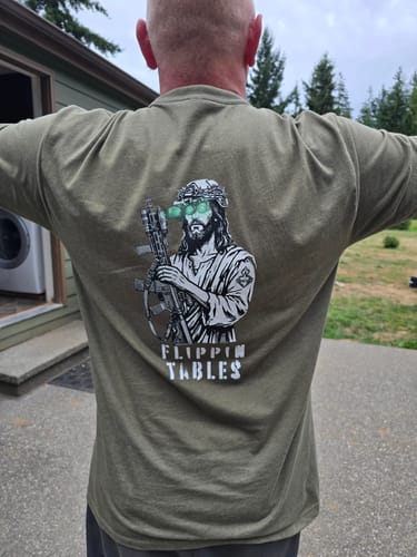 Reviewer from behind wearing the olive green Flippin' Tables T-Shirt, showing the back graphic.