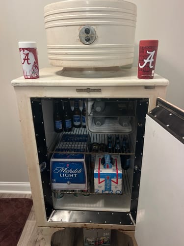 Customer's two Alabama Crimson Tide Universal Buddy can coolers displayed on top of a retro, open refrigerator.
