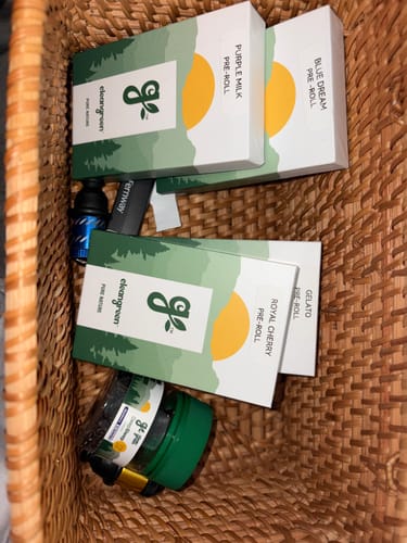 Customer's Explorer Pack contents, including several pre-roll boxes and a product jar, arranged in a woven basket.