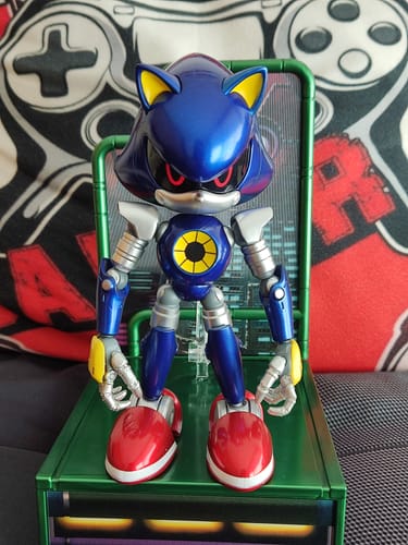 Customer's shiny blue Modern Metal Sonic figure posed on its green display stand against a patterned background.