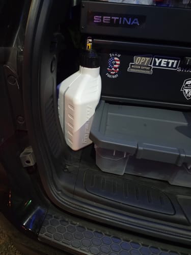 Customer's white 1.25 Gallon Jug stored in the cargo area of a police K9 vehicle.