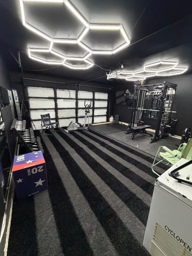 Customer's home gym, showing the power rack setup where the RitFit LHM1 Leg Holder Attachment is used.