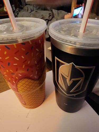 Customer's two Frost Buddy tumblers, one with a colorful ice cream design and one with a black knight logo.