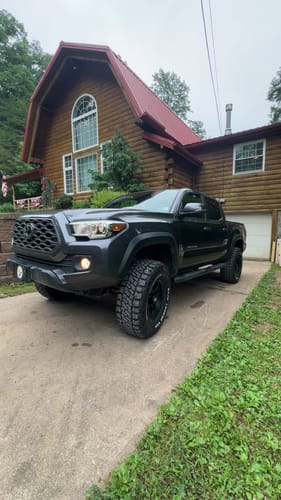 Customer's dark gray Toyota Tacoma with a leveled stance after installing the 1.5" Front Leveling Lift Kit.