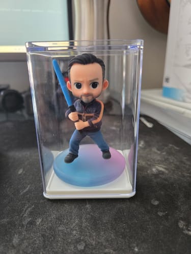 Customer's Dust-Proof Acrylic Display Case showing a small figurine of a man holding a blue sword inside.