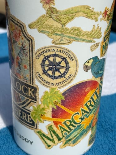 Close-up of the customer's Universal Buddy can cooler showing the detailed Margaritaville-themed design.