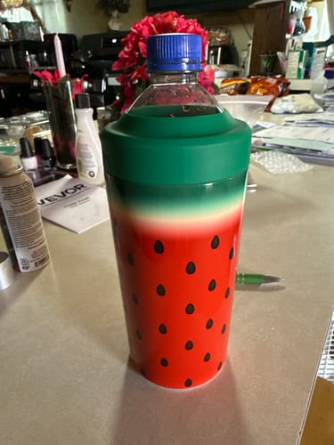 Customer's Watermelon Kiss Universal Buddy holding a plastic beverage bottle on a kitchen counter.