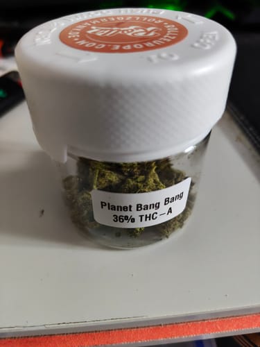 Customer's clear jar of Planet Bang Bang flower, with a label showing it contains 36% THC-A.