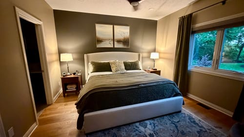 Customer's Heron's Morning art set displayed on a charcoal accent wall above the bed in their bedroom.