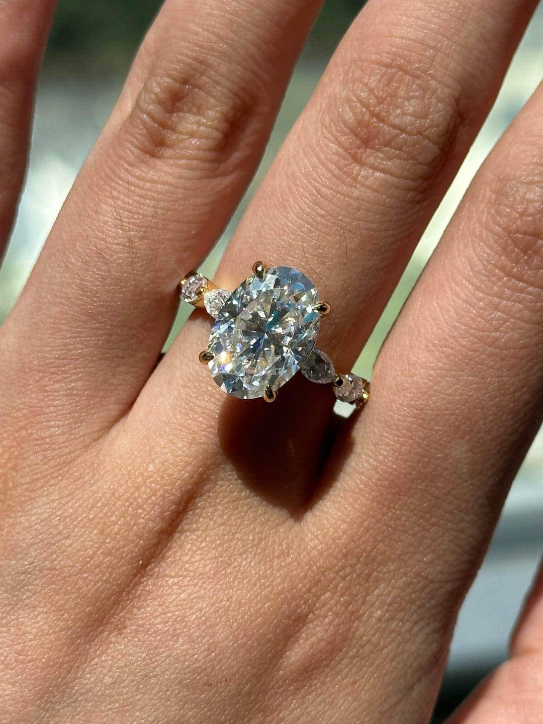 Customer photo review of Moissanite 5.5Ct Oval Cut with 1.5Ct Side Stone Marquise Cut Engagement Ring in S925 Sterling Silver