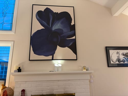Customer's large Midnight Bloom canvas art hanging above a white brick fireplace in a living room.