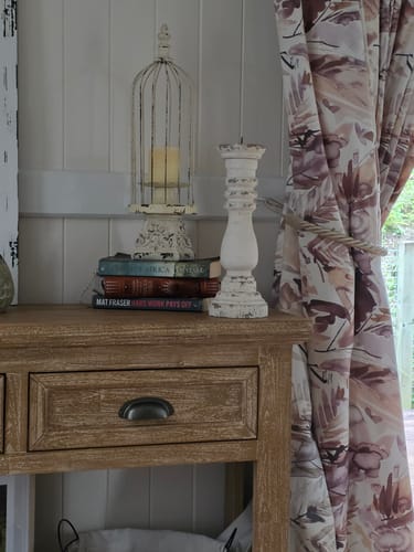 Customer's distressed white Francesca Classic Candle Holder displayed on a rustic wooden console table.