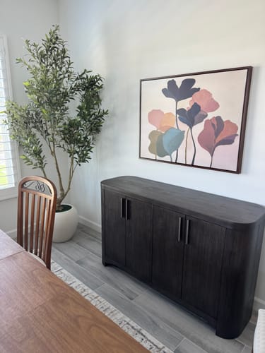 Customer's Autumn Garden Canvas Art hanging on a dining room wall above a dark wood sideboard.