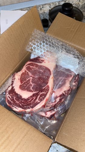 Customer's raw Halal Ribeye Steak, vacuum-sealed and newly delivered in a box.