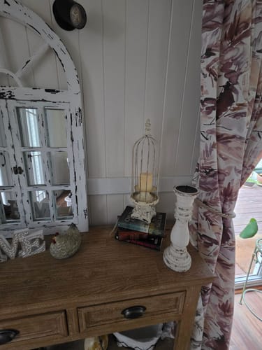 Customer's François Birdcage Candle Holder displayed on a wooden console table with a candle inside.