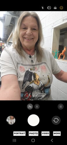 Reviewer smiling in a selfie wearing The Firecracker Tarot Card Tee.