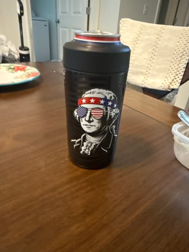 Customer's black Universal Buddy American Icon cooler with a patriotic design, holding a can on a wooden table.