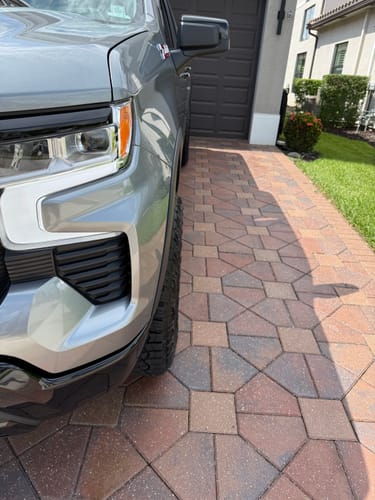 Close-up of a customer's silver Chevy Silverado, showing the wider tire stance from the 1.5" wheel spacers.