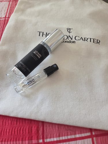 Customer's Lilium Blume Eau de Parfum spray bottle resting on a branded cloth bag.