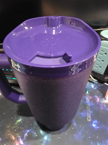 Close-up of a reviewer's purple glitter Thicc Buddy 50oz mug, showing the textured finish and matching lid.