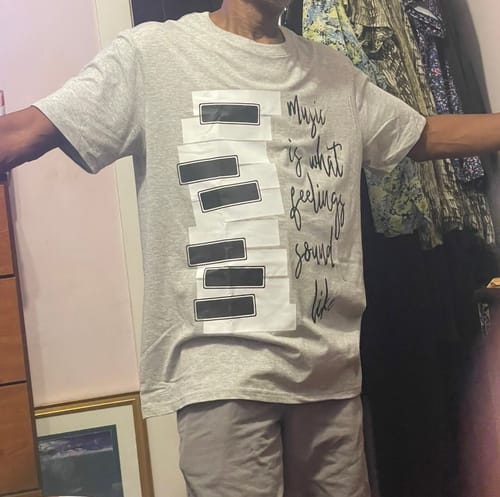 Customer wearing the grey Slide To Play T-Shirt, showing the piano key graphic and roomy fit.