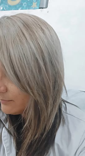 Reviewer showing their cool, ashy blonde hair after using the Milk Shake Icy Blond set.
