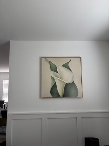 Customer's Calla Duo Canvas Art hanging on a white wall above wainscoting.