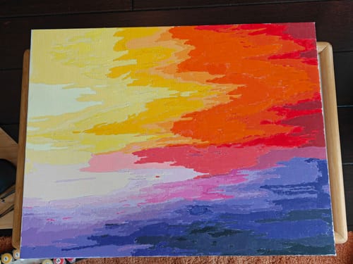 Reviewer's finished paint-by-numbers canvas showing a colorful abstract sunset.