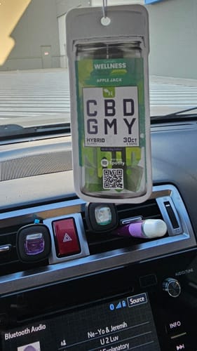 Customer's air freshener for car hanging from the rearview mirror inside a vehicle.