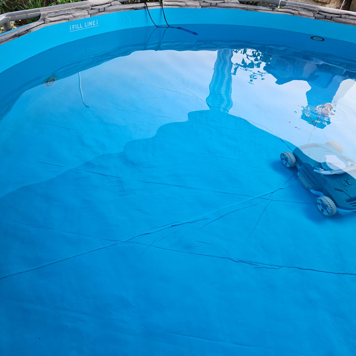 Klares Poolwasser in einem runden Aufstellpool, die Bodenfolie ist deutlich zu erkennen