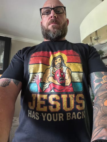 Customer wearing the black Jesus Has Your Back T-Shirt, showing the detailed front graphic.