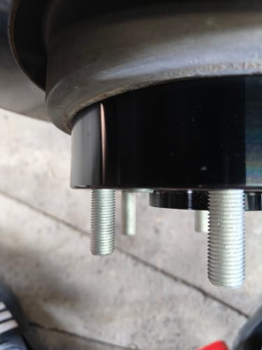 Customer's close-up of a 1.5 inch hubcentric wheel spacer installed on a truck, showing stud clearance.
