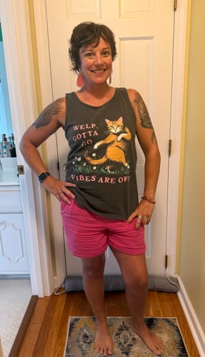 Reviewer showing the fit of the dark grey 'Welp Gotta Go Vibes Are Off' tank top.