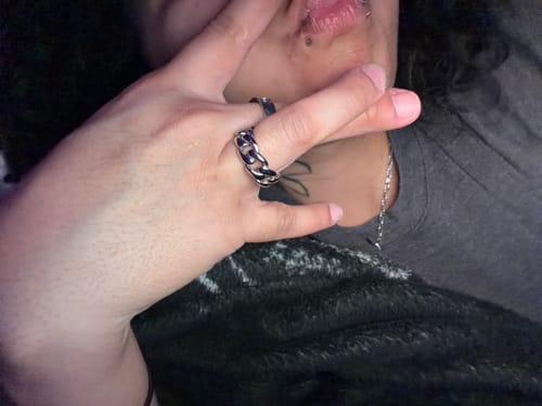 Close-up of a reviewer wearing the silver-colored Cuban Ring on their finger.