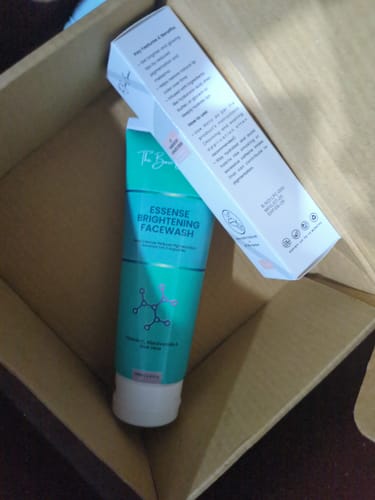 Customer's Essense Brightening Facewash tube and the Lip Pigmentation Cream box from the bundle, viewed in shipping packaging.