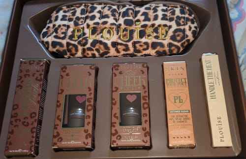 Customer's July Budget Box displayed with a leopard-print makeup bag and matching packaged beauty products.