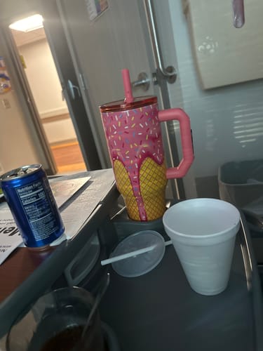 Customer's Mystery Thicc Buddy tumbler with a pink ice cream cone design, sitting on a tray in a room.