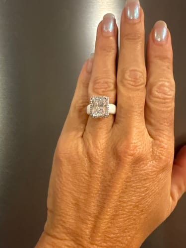 Reviewer's hand wearing the white Rinfit Halo Silicone Ring with its large, emerald-cut stone and sparkling halo setting.