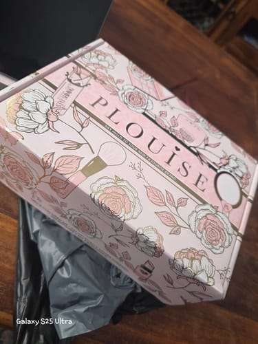 Customer's pink floral box for the Skin Barrier Repair Set, shown on a wooden table.