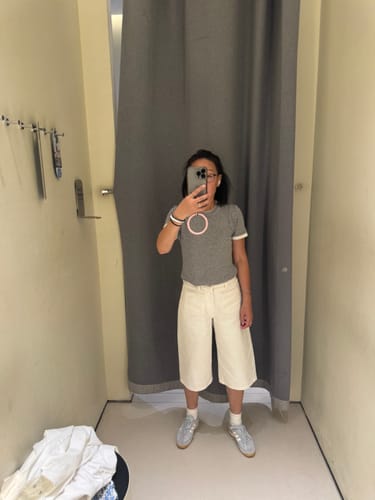Reviewer showing the fit of the off-white Cotton Patch Pocket Cropped Jeans in a fitting room.
