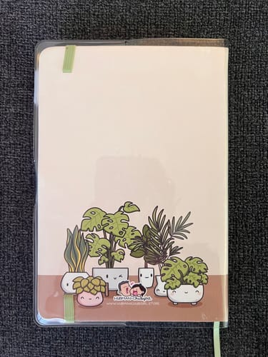 Customer showing the back of the clear PVC journal cover on their plant-themed journal.