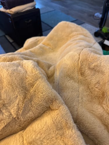 A customer's close-up of the soft, plush Lush True Caramel Blanket, highlighting its warm texture.